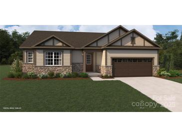 Charming single-story home with stone accents, well-maintained lawn, and a two-car garage at 1619 Honey Trl, Monroe, NC 28112