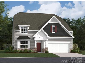 Charming two-story home showcasing a well-manicured lawn and attached two-car garage at 2803 Morning Song Way, Lancaster, SC 29720