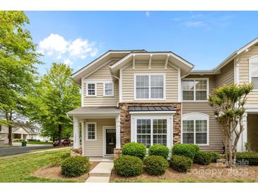 Charming two-story home featuring stone accents and manicured landscaping at 1001 Woodglen Ln, Matthews, NC 28104