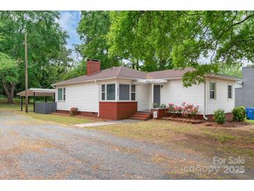 Charming single-story home featuring a welcoming front porch, brick accents, and a well-maintained lawn at 1116 Montgomery Ave, Albemarle, NC 28001