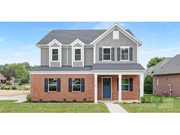 Charming two-story home with brick and gray siding, complemented by a well-manicured lawn at 1701 30Th Avenue Ne Ct, Hickory, NC 28601