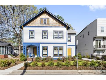 Charming two-story home featuring colorful accents, a welcoming porch, and fresh landscaping at 210 Walford Dr, Charlotte, NC 28208