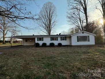 Charming one-story home with a covered parking, green shutters, and manicured bushes at 539 Jennings Rd, Statesville, NC 28625