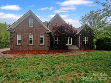 Brick home with a manicured lawn and mature landscaping at 6204 River Birch Dr, Gastonia, NC 28056