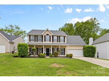 Charming two-story home with a welcoming front porch and lush landscaping at 879 Knightsbridge Rd, Fort Mill, SC 29708