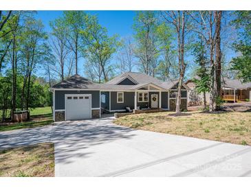 Charming single-story home with a garage and a concrete driveway and beautifully landscaped front yard at 912 Westside Dr, Newton, NC 28658