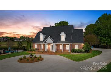 Charming brick home boasts a manicured front yard, circular driveway, and inviting curb appeal at 105 Snead Ct, Salisbury, NC 28144