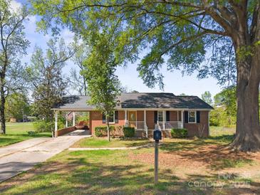 Charming brick ranch with a cozy front porch and convenient carport at 1337 Eastside Ave, Albemarle, NC 28001