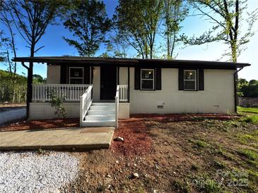 Charming single-story home with white painted brick and a quaint front porch at 1407 Clarksville Campground Rd, Monroe, NC 28112