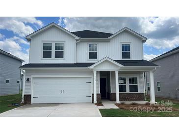 Charming two-story home featuring a two-car garage, a covered entryway, and a well-manicured lawn at 142 Aberdeen Dr, Salisbury, NC 28144