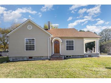 Charming single-story home featuring a cozy front porch, traditional windows and a well-maintained lawn at 2001 S Main St, Kannapolis, NC 28081