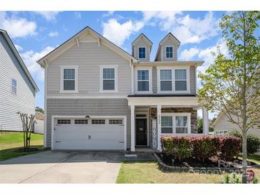 Beautiful two-story home with a cozy front porch, attached garage, and lovely curb appeal at 2220 Atwell Glen Ln, Pineville, NC 28134