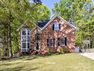 Charming two-story brick home with a well-manicured lawn and lush landscaping, offering classic curb appeal at 2805 Bathgate Ln, Matthews, NC 28105