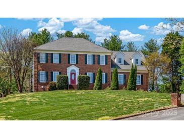 Traditional two-story brick home with a manicured lawn and symmetrical design, accented by dark green shutters at 4405 3Rd Nw St, Hickory, NC 28601