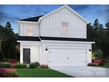 Charming two-story home with a two-car garage, black roof, and white siding nestled on a well-manicured lawn at 5020 Poplin Vly, Cherryville, NC 28021