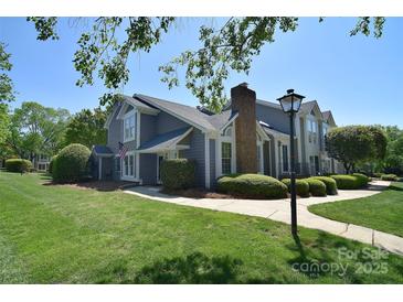 Charming two-story home with a well-manicured lawn, complemented by lush greenery and a sidewalk leading to the entrance at 8257 Legare Ct, Charlotte, NC 28210