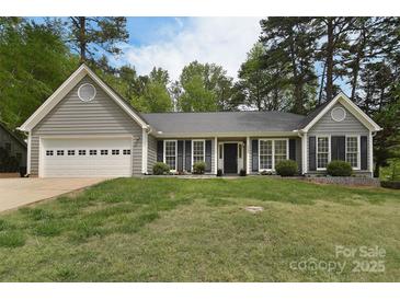 Charming single-story home with gray siding, black shutters, and a well-manicured lawn at 9208 Plashet Ln, Mint Hill, NC 28227