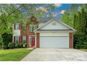 Charming two-story home with a brick and siding exterior, and an attached two-car garage at 13228 Crooked Pine Ct, Charlotte, NC 28215