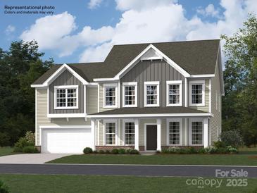 Charming two-story home showcasing a welcoming front porch and a well-manicured lawn at 1512 Croydon St, Indian Land, SC 29707