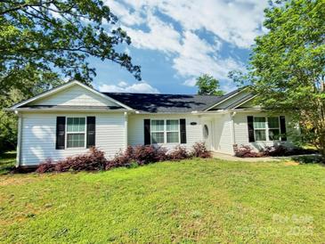 Charming single-story home with a well-maintained lawn, mature trees, and classic black shutters at 252 S Potter Rd, Lancaster, SC 29720