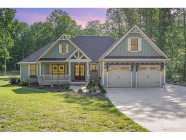 Charming home featuring a well-manicured lawn and a three-car garage at 2586 Lee Lawing Rd, Lincolnton, NC 28092