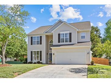 Charming two-story home with a well-maintained lawn, two car garage, and classic architectural details at 3831 Robeson Creek Dr, Charlotte, NC 28270