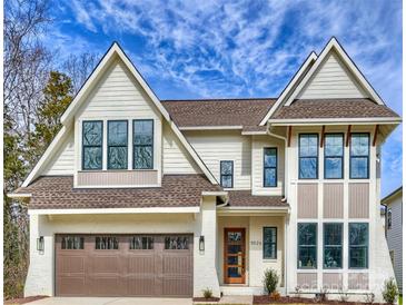 New construction with a light-colored brick, dark window frames, and beautiful architecture against a gorgeous blue sky at 5010 Ohm Ln, Charlotte, NC 28270