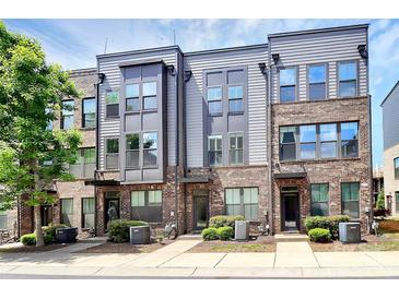 Exterior view of modern townhomes with brick and gray siding, showcasing their contemporary design at 510 Music Hall Way, Charlotte, NC 28203