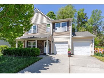 Charming two-story home with a well-manicured lawn, a two-car garage, and stone accents at 602 Black Maple Dr, Kannapolis, NC 28081
