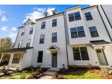 Charming, newly built townhome featuring a modern white facade and well-manicured landscaping at 657 District Ct, Fort Mill, SC 29708