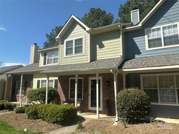 Charming townhouse with a brick facade and well-maintained landscaping, showcasing its inviting curb appeal at 9305 Four Mile Creek Rd, Charlotte, NC 28277