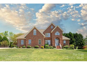 Charming two-story brick home featuring a manicured lawn and professionally landscaped garden beds at 1103 Hillcrest Ridge Dr, Salisbury, NC 28146