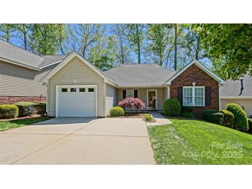 Charming single-story home with a well-maintained front yard, attached garage, and inviting entrance at 115 Keswick Ln, Mooresville, NC 28117