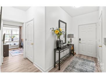 Inviting foyer featuring a decorative table, mirror, and neutral decor at 12357 Copper Mountain Blvd, Charlotte, NC 28277