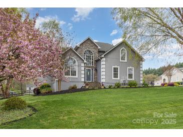 Charming home with a stone accent and lush green lawn, perfect for outdoor enjoyment at 130 Hopedale Ct, Mooresville, NC 28117