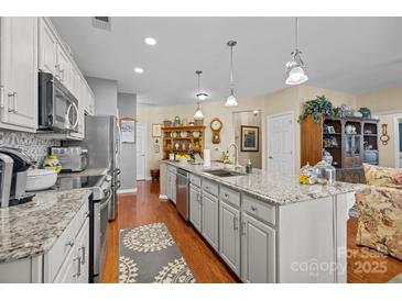 Spacious kitchen with granite counters, stainless appliances, and large center island at 14869 Santa Lucia Dr, Charlotte, NC 28277