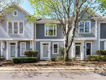 Charming townhomes featuring gray siding, white trim, and well-maintained landscaping, offering a welcoming curb appeal at 1568 Cleveland Ave, Charlotte, NC 28203