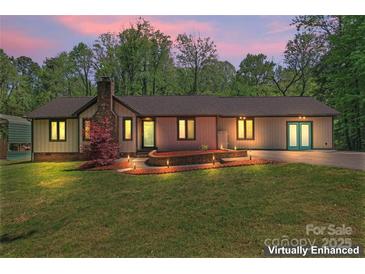 Charming one-story home featuring a brick chimney, well-manicured lawn, and inviting curb appeal at 2615 Toddville Rd, Charlotte, NC 28214