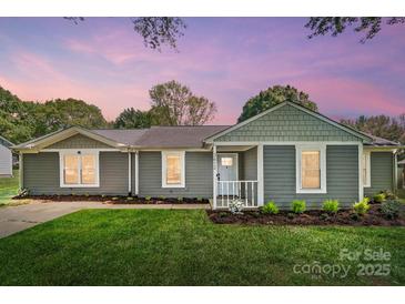 Charming single-story home with a well-manicured lawn and inviting front porch at 3612 Cobbleridge Dr, Charlotte, NC 28215