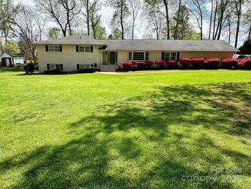 Ranch-style home boasting a lush green lawn and mature landscaping at 3713 Saint Regis Dr, Gastonia, NC 28056