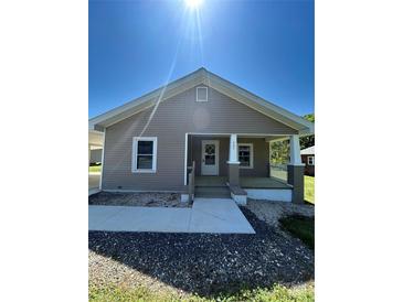 Charming single-story home with a cozy front porch and well-maintained landscaping at 427 W Whitley St, Norwood, NC 28128