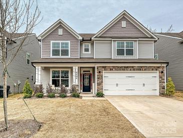 Charming two-story home featuring a two-car garage, stone accents, and a well-maintained lawn at 4606 Gatesmills Ave, Charlotte, NC 28213