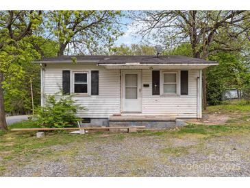 Quaint one-story home with a small front porch and mature trees, offering a cozy curb appeal at 545 S Green St, Statesville, NC 28677