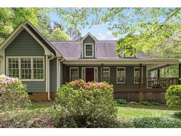 Charming home featuring a cozy front porch and lush landscaping, perfect for enjoying the outdoors at 705 Normandy Rd, Mooresville, NC 28117
