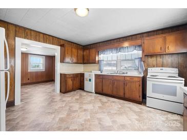 Bright kitchen features wood cabinets, vinyl floors, and modern appliances at 71 14Th Se St, Hickory, NC 28602