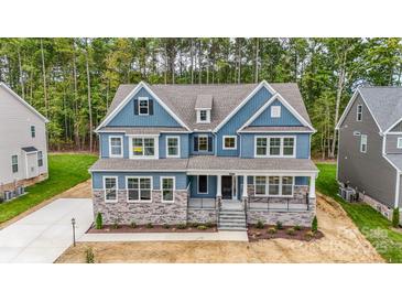 Charming blue two-story home with stone accents and a welcoming front porch at Tbd Boomer Ct # 1, Statesville, NC 28677