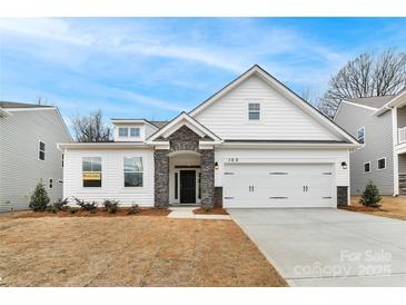 Charming white two-story home featuring a two-car garage and a beautifully landscaped front yard at Tbd Boomer Ct # 2, Statesville, NC 28677