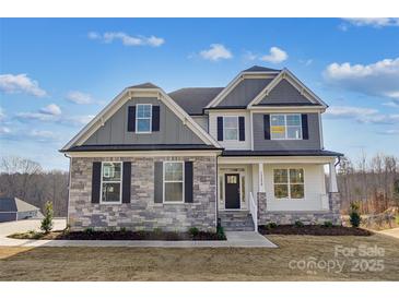 Two-story home with stone and siding exterior, well-manicured lawn, and inviting entryway at Tbd Boomer Ct # 3, Statesville, NC 28677