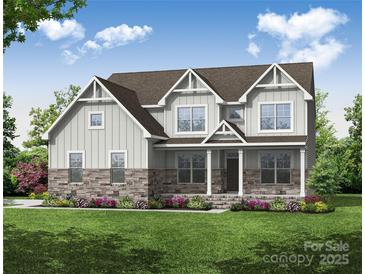 Charming two-story home with stone accents, gray siding and landscaped front yard at Tbd Boomer Ct # 5, Statesville, NC 28677