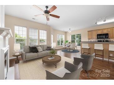 Bright living room featuring large windows, neutral tones, and an open concept design at 11544 Costigan Ln # 8306, Charlotte, NC 28277